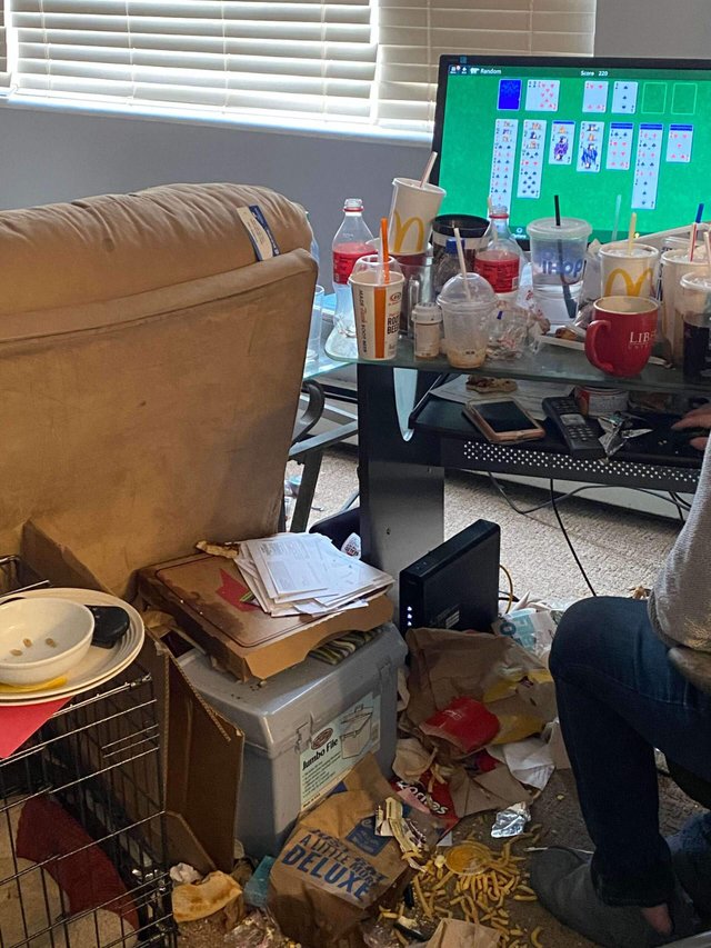 Heavily cluttered home interior before cleanup